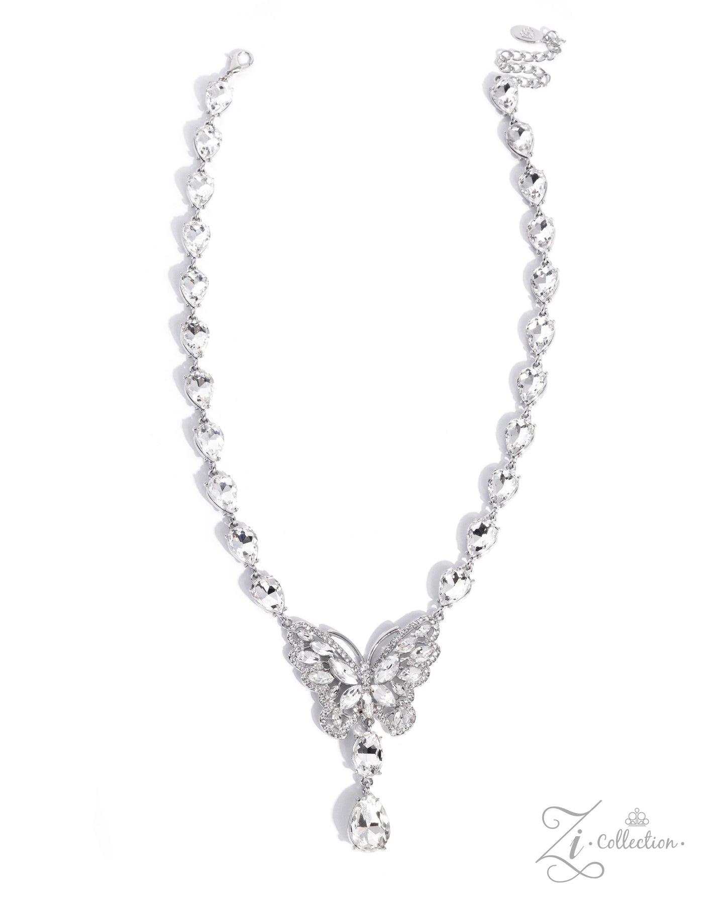 A silver-toned necklace featuring a delicate chain with small heart-shaped links, a butterfly motif paved with clear stones at the center, and a teardrop-shaped clear stone hanging from the bottom, shown on a white background with a Zi Collection logo in the corner.