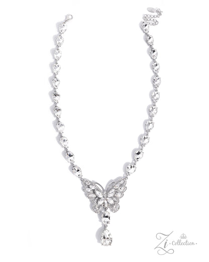 A silver-toned necklace featuring a delicate chain with small heart-shaped links, a butterfly motif paved with clear stones at the center, and a teardrop-shaped clear stone hanging from the bottom, shown on a white background with a Zi Collection logo in the corner.