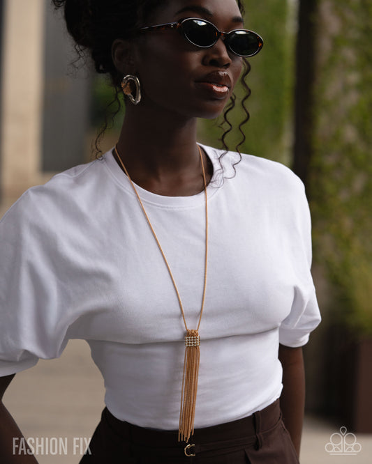 Person wearing a white top and sunglasses with a blurred background