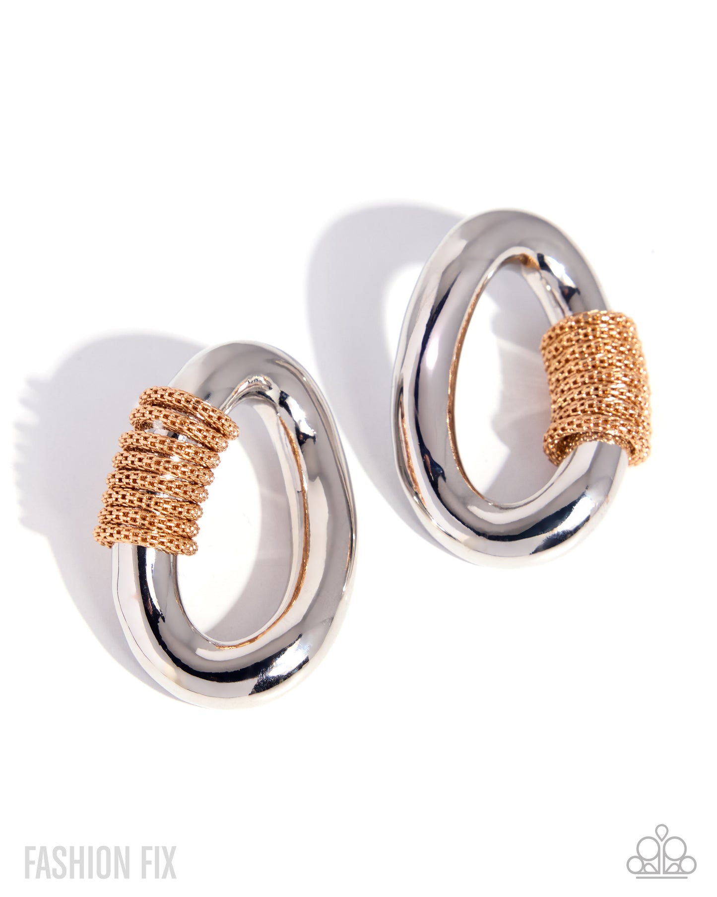 Pair of silver and rose gold hoop earrings on a white background