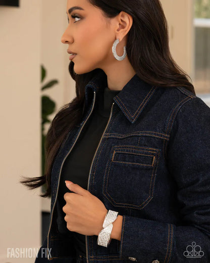 Woman wearing a dark denim jacket with a blurred background