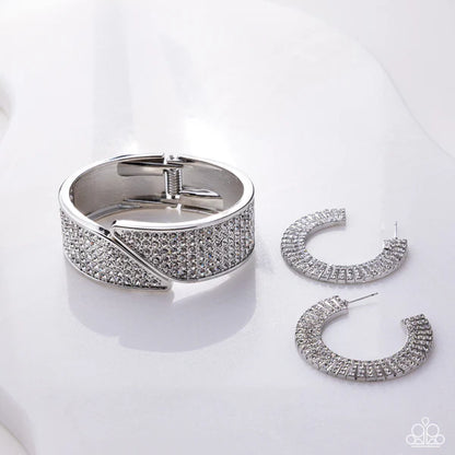 Silver bracelet and hoop earrings on a white background