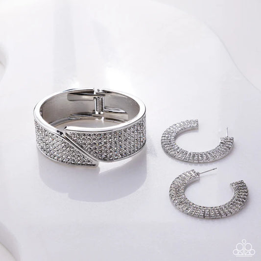 Silver bracelet and hoop earrings on a white background