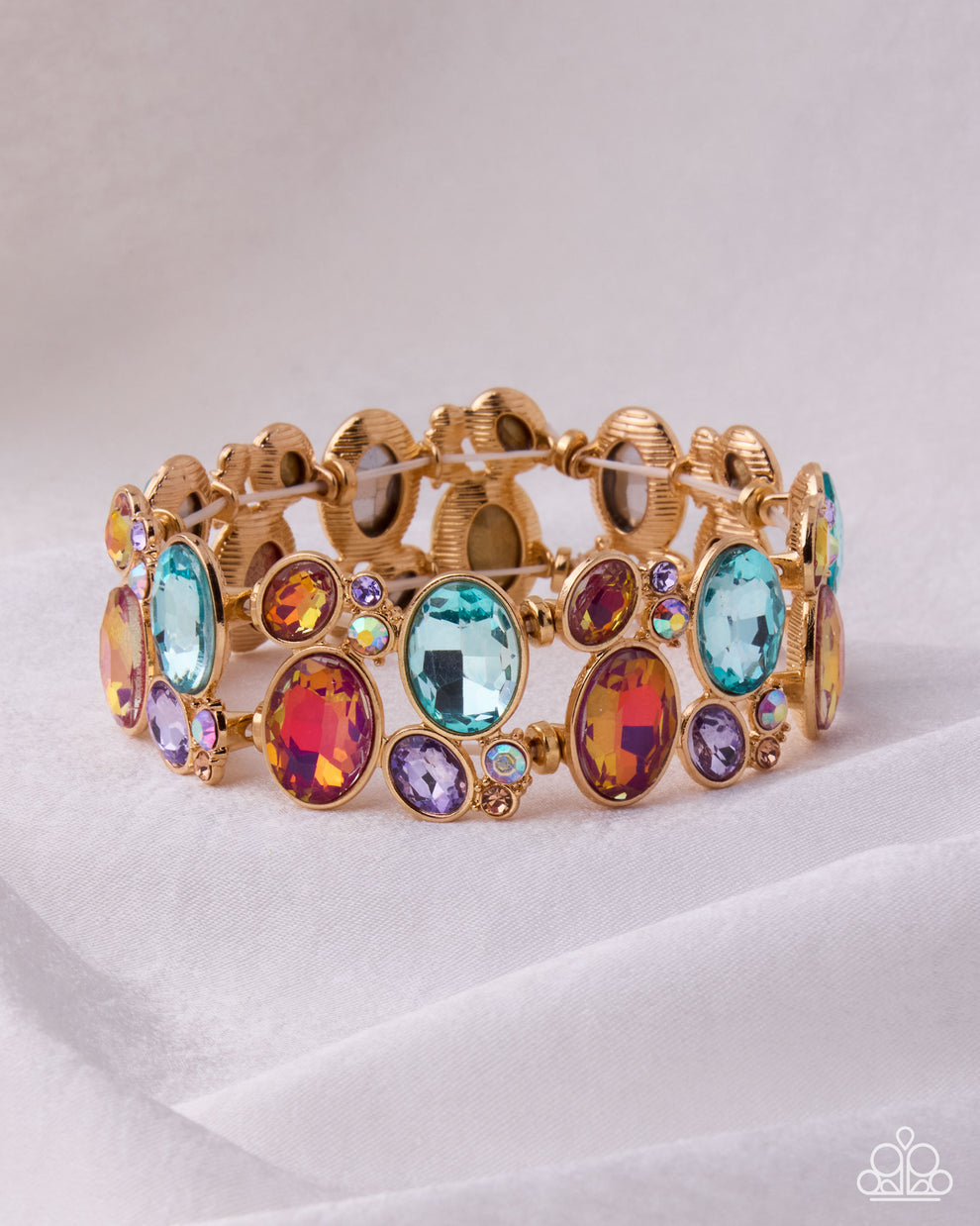 Gold bracelet with colorful gemstones on a white background