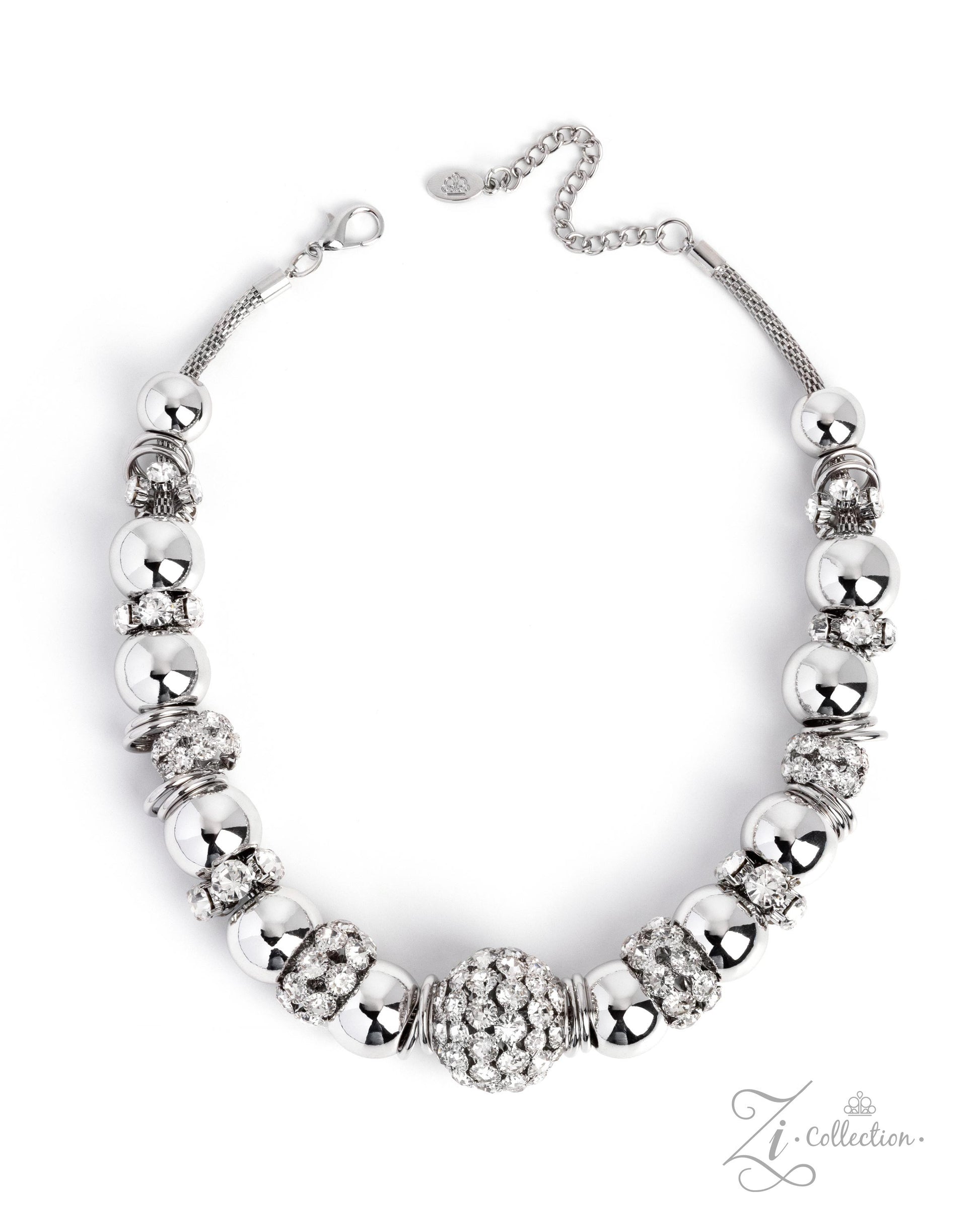 A silver-toned statement necklace featuring a central cluster of clear rhinestones surrounded by alternating polished silver beads and textured spacer beads, displayed on a clean white background.
