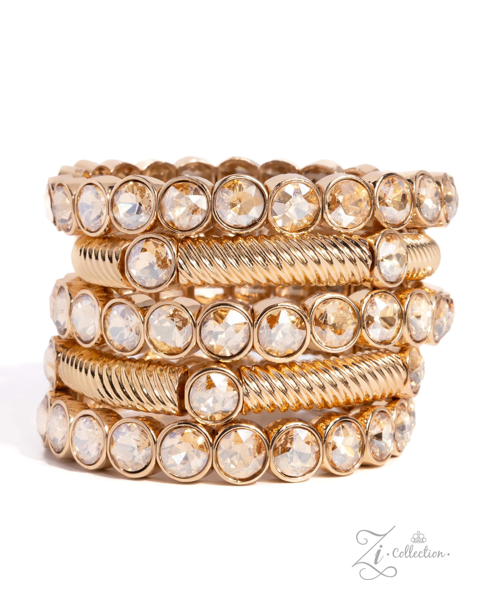 A stack of five gold-toned bangles, featuring alternating smooth bands and twisted rope-style bands, all embellished with clear faceted round crystals, set against a plain white background.