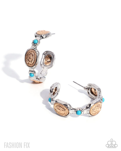 A pair of silver hoop earrings with textured rose gold oval charms, small turquoise blue beads, and silver post backings, displayed on a clean white background.