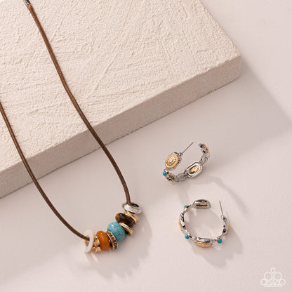 A jewelry set featuring a brown cord necklace with colorful spacer beads and matching silver hoop earrings with gold and turquoise accents, styled on a textured cream block and a light beige surface.