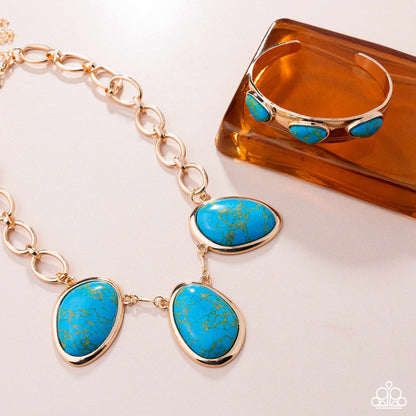 Jewelry set with turquoise stones and gold accents on a white background