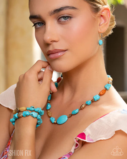 Woman wearing a turquoise beaded necklace and earrings with a blurred background