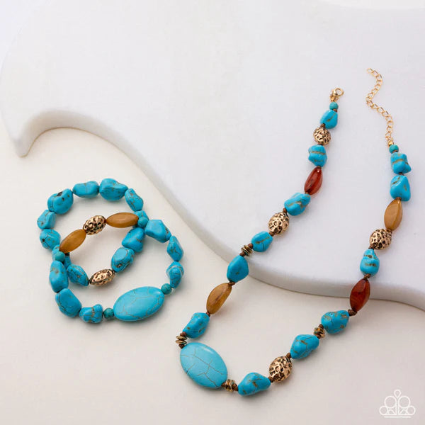 Turquoise and brown beaded necklace and bracelet on a white surface
