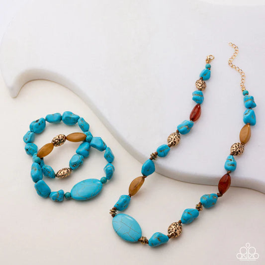 Turquoise and brown beaded necklace and bracelet on a white surface