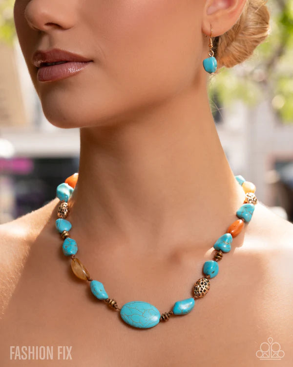 Close-up of a woman wearing a turquoise and orange beaded necklace with blurred background