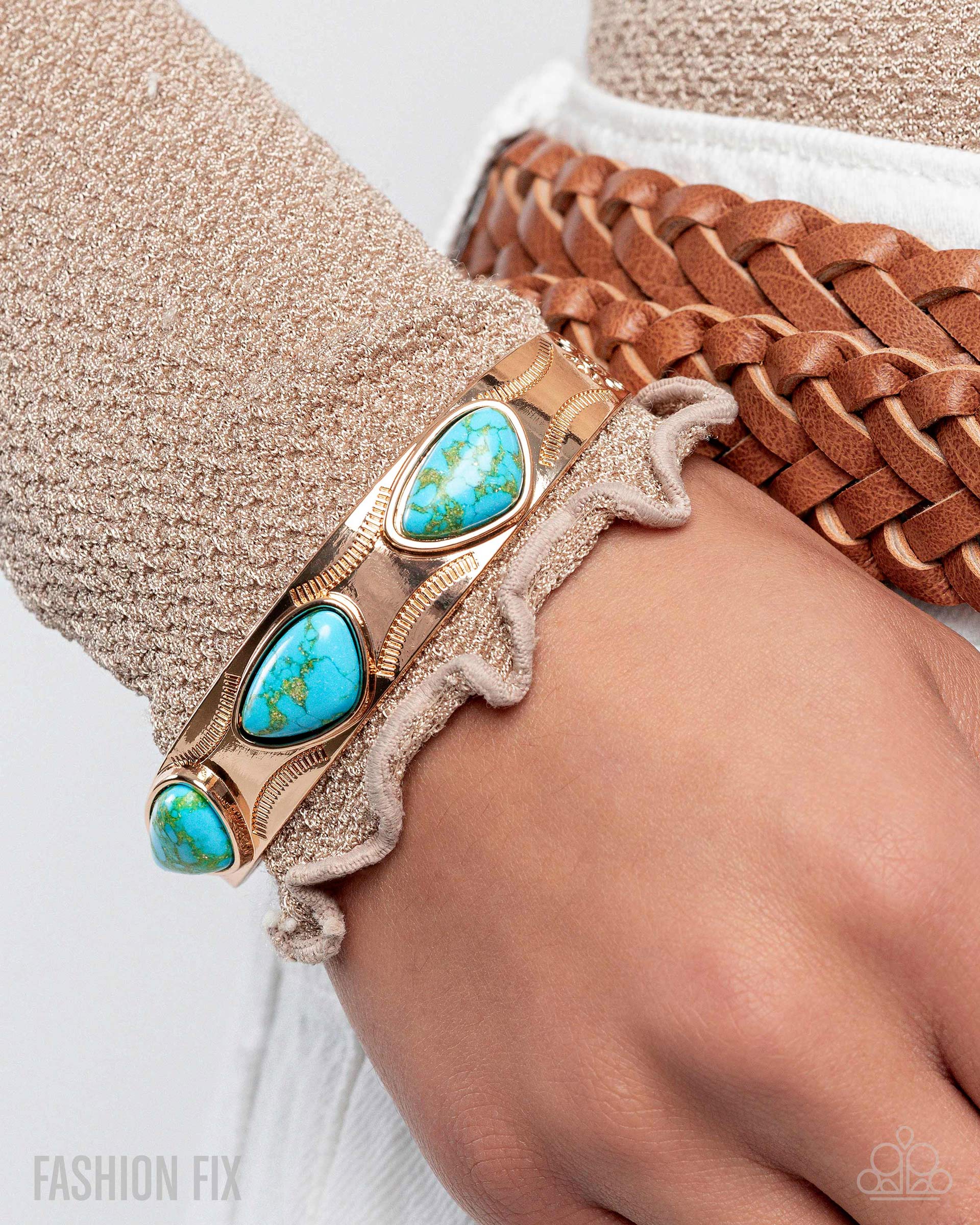 Turquoise stone bracelet on a wrist with a textured background