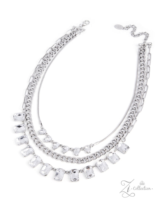 A silver-toned multi-strand necklace featuring a chunky chain, a delicate chain, and a central layer adorned with clear rectangular and heart-shaped rhinestones, shown on a plain white background.