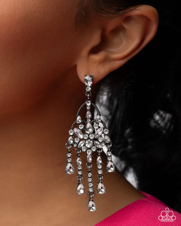 Close-up of a person wearing a sparkling silver earring.