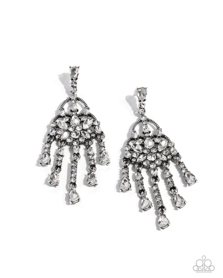 Pair of silver chandelier earrings with clear stones on a white background