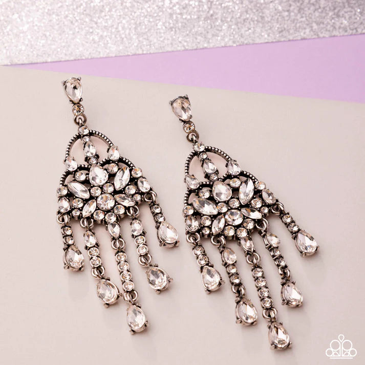 Pair of ornate chandelier earrings on a light background