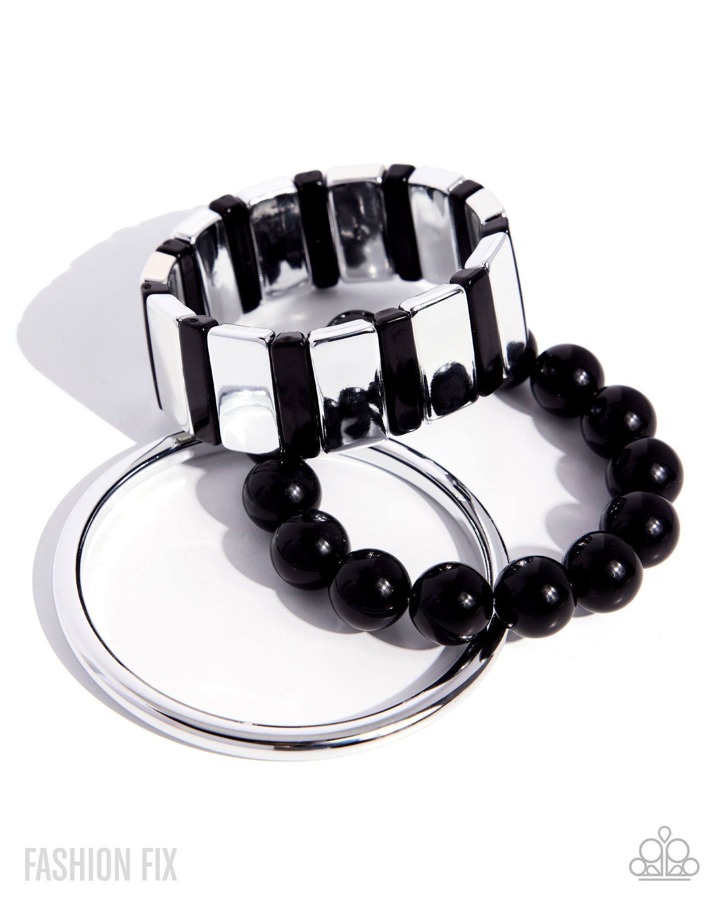 Silver and black bracelet set on a white background