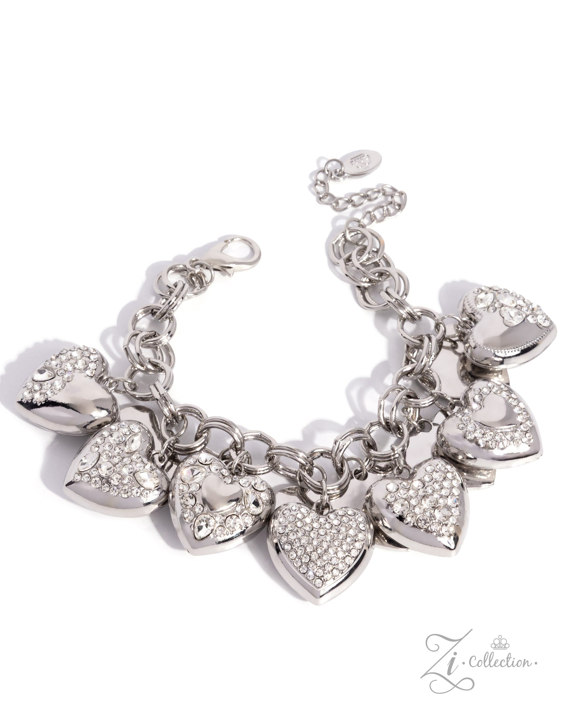 A silver-tone charm bracelet featuring multiple heart-shaped charms, some adorned with clear rhinestones, displayed on a clean white background.