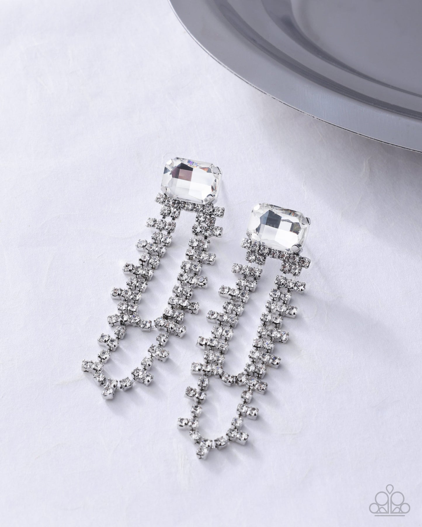 Balanced Birthright white earrings flat lay