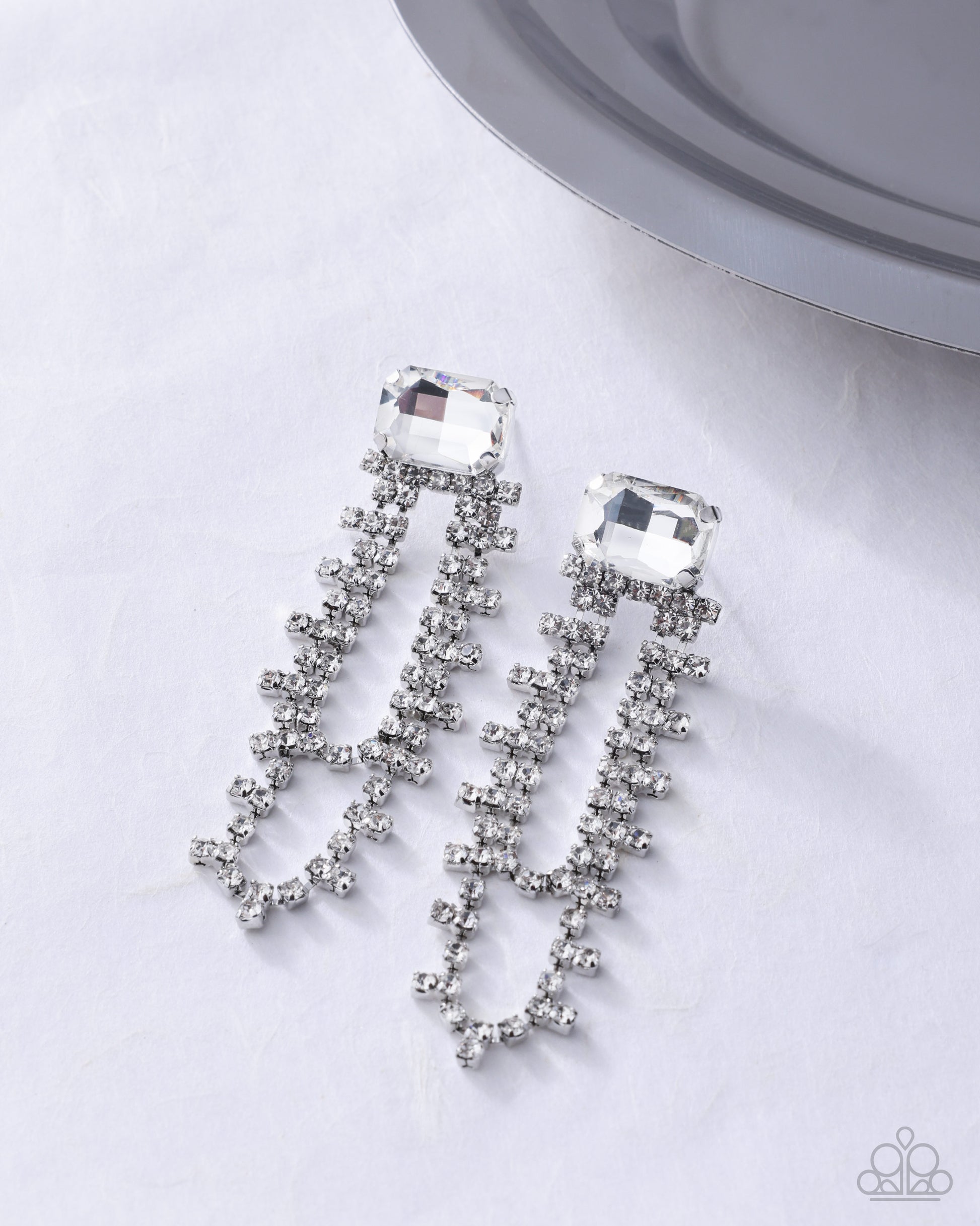 Balanced Birthright white earrings flat lay