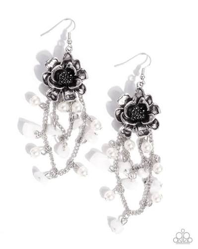 Pair of silver earrings with black floral designs on a white background