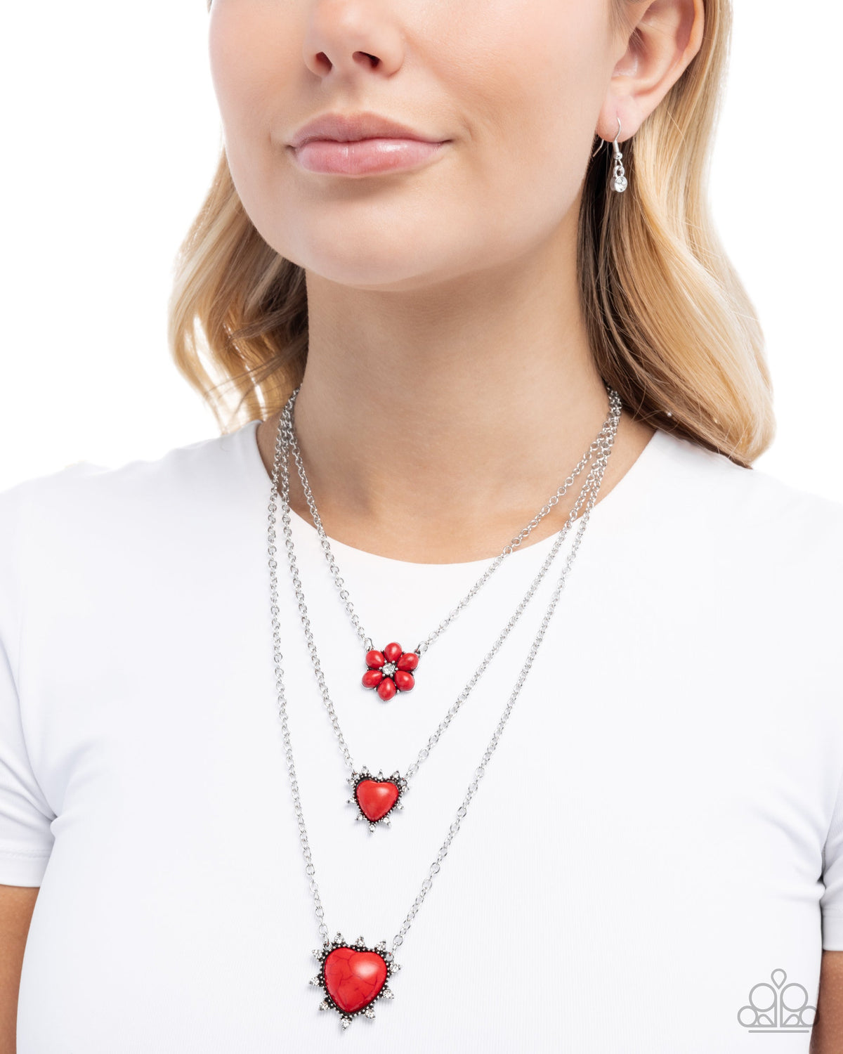 Close-up of the Santa Fe Spar red stone heart pendants and silver chains.