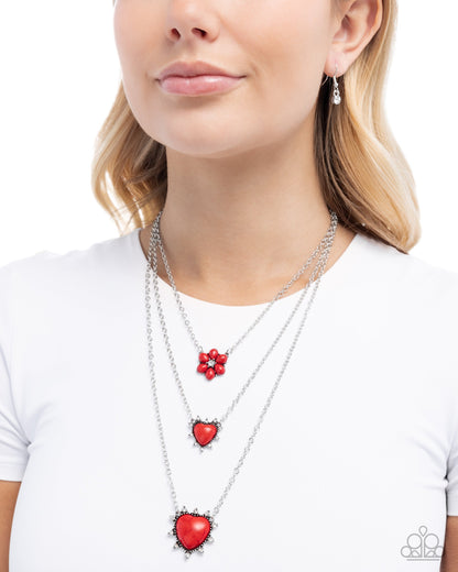 Close-up of the Santa Fe Spar red stone heart pendants and silver chains.