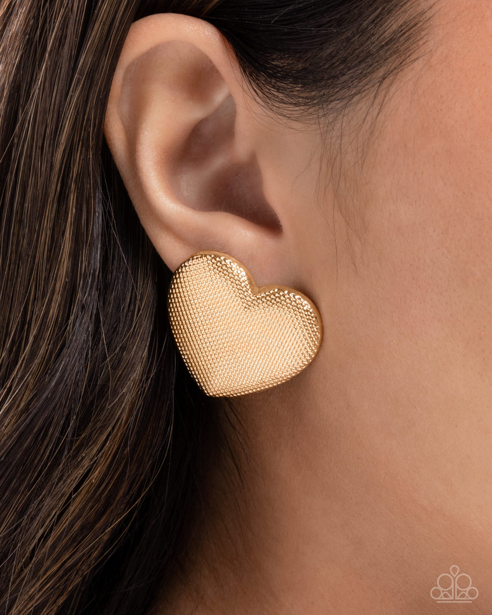 Smitten Studs oversized gold heart earrings shown on model